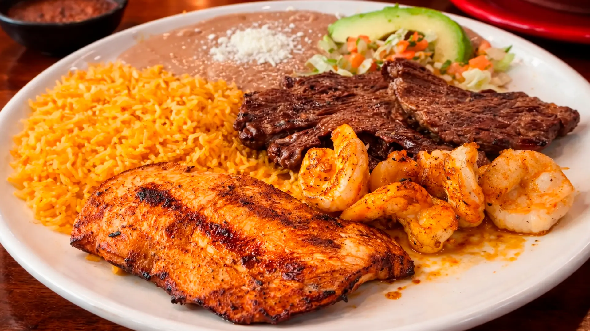 Sizzling parrillada platter of grilled meats, peppers and onions